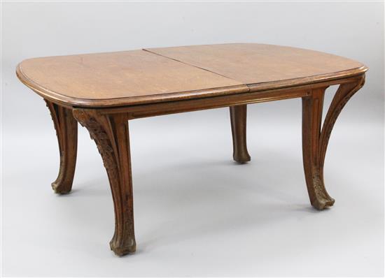 A Louis Majorelle Chicoree pattern oak dining table and six chairs, 5ft 2in. x 4ft 2in., extends to 12ft